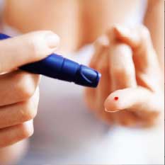 a person testing sugar level using blood from index finger